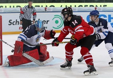 ZUG, SWITZERLAND - APRIL 21: Canada's Matt Barzal #14 with a scoring chance against Finland's Veini Vehvilainen #1 while Otto Leskinen #5 defends during preliminary round action at the 2015 IIHF Ice Hockey U18 World Championship. (Photo by Francois Laplante/HHOF-IIHF Images)